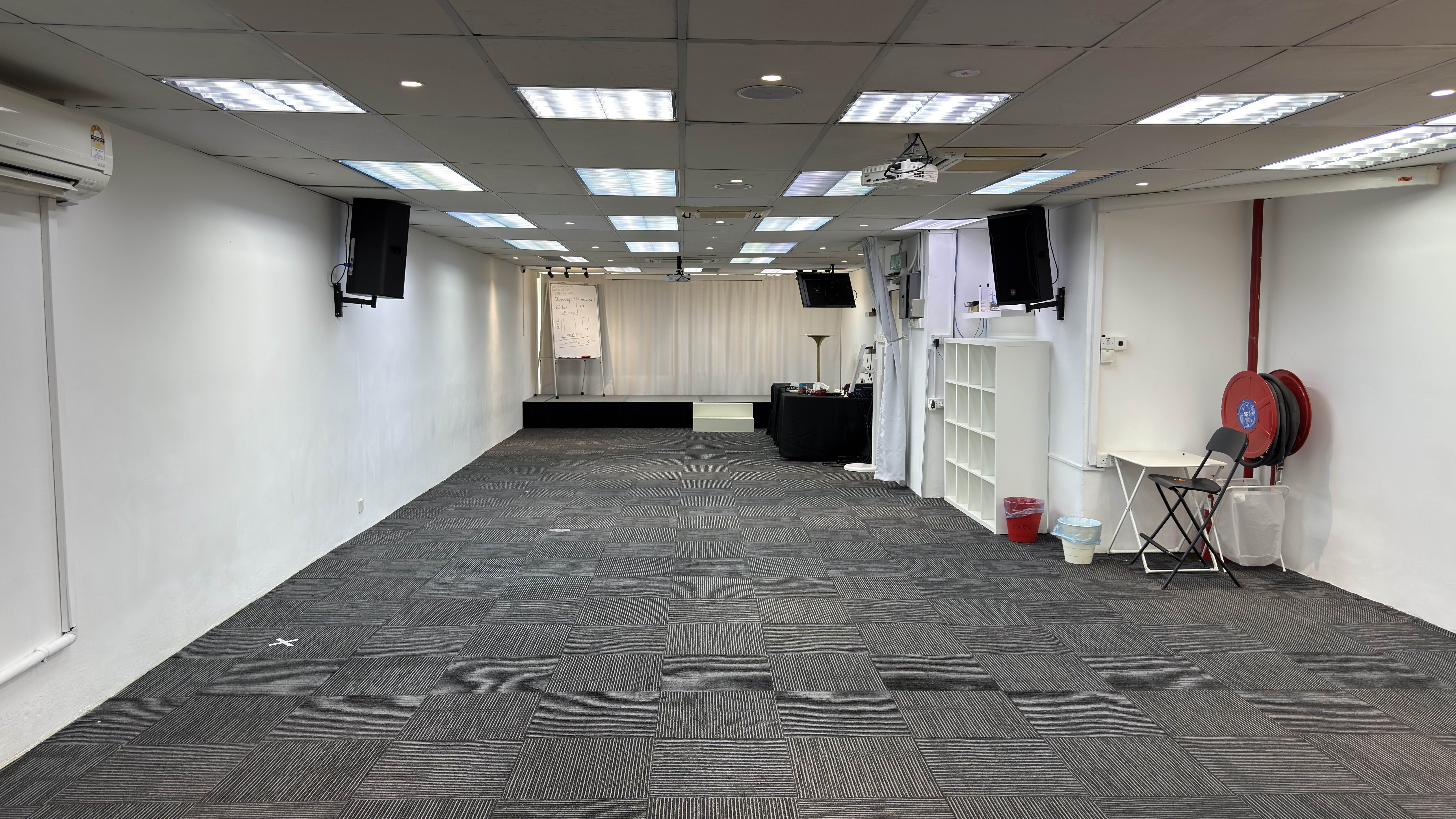 Training hall facing the small stage and white curtain backdrop
